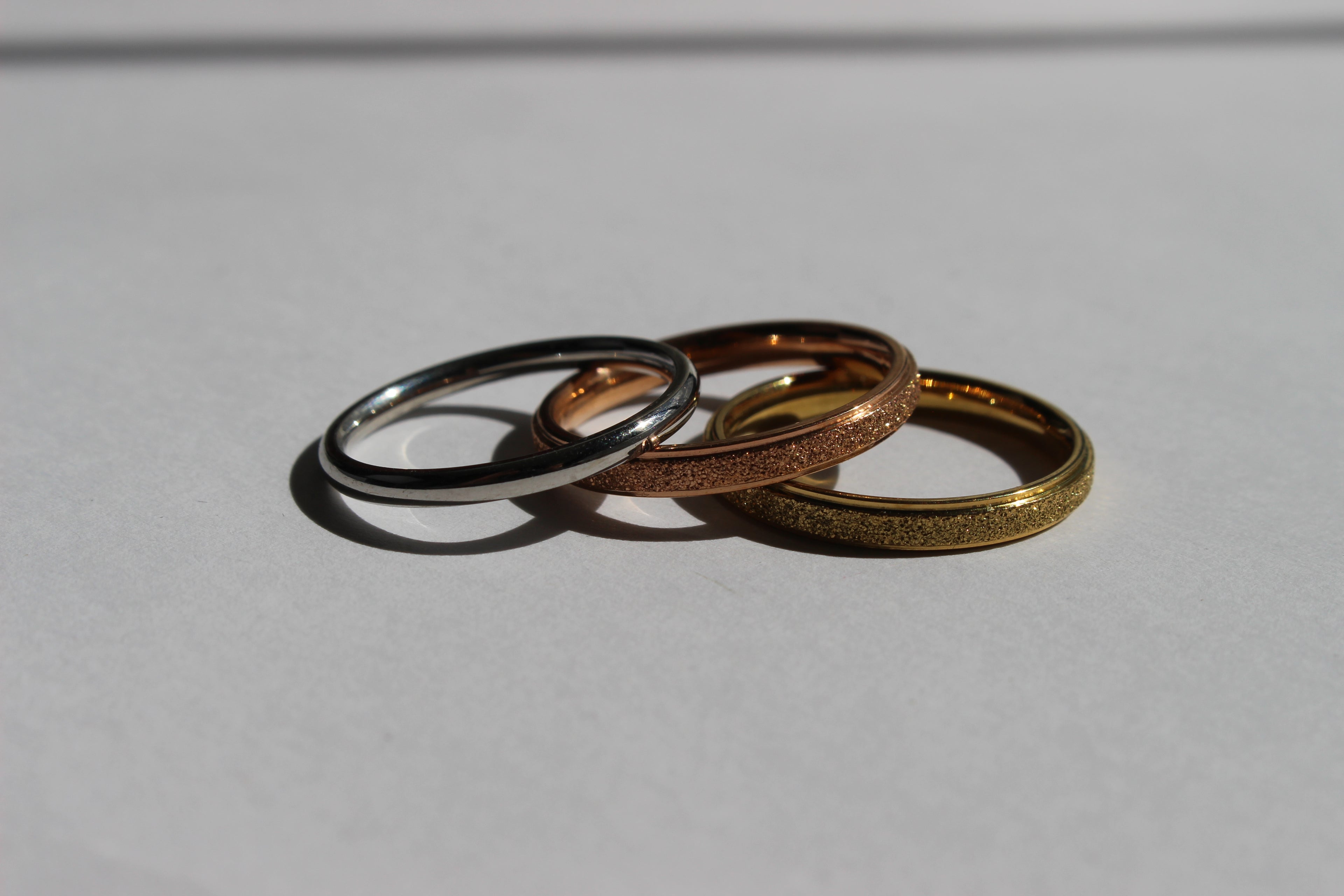 ETERNA GLOW STAINLESS STEEL BAND RINGS .