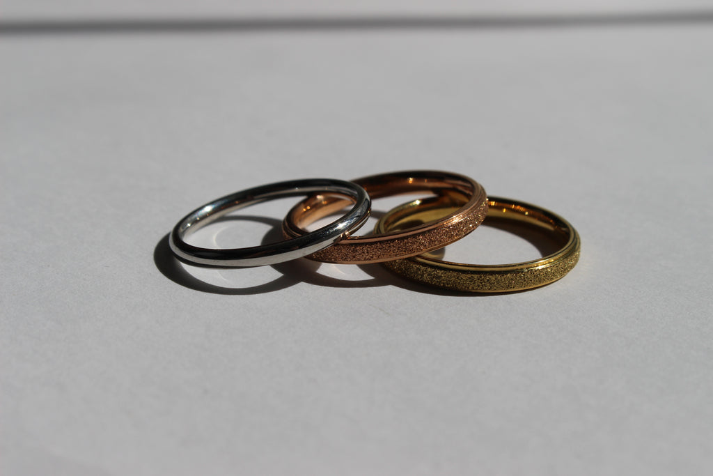 ETERNA GLOW STAINLESS STEEL BAND RINGS .